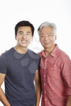 Studio Portrait Of Chinese Father With Adult Son