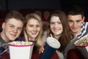 Group Of Teenage Friends Watching Film In Cinema