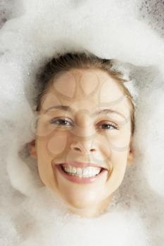 Woman Relaxing In Bubble Filled Bath