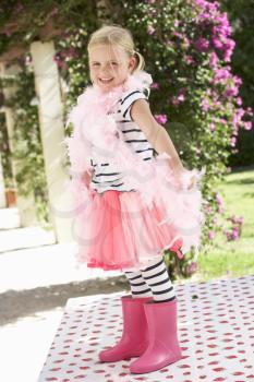 Young Girl Wearing Pink Wellington And Feather Boa