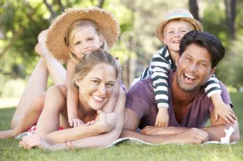 Family Relaxing In Park Together