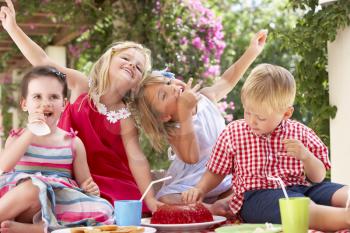 Group Of Children Eating Jelly At Outdoor Tea Party