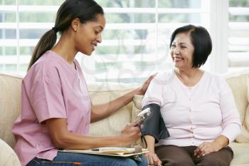 Nurse Visiting Senior Female Patient At Home