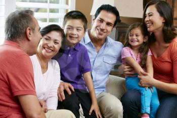 Multi Generation Family Relaxing At Home Together