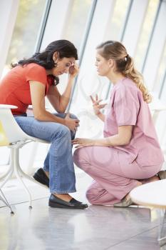 Female Nurse Offering Counselling To Depressed Woman