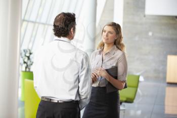 Businessman And Businesswoman Having Meeting In Office