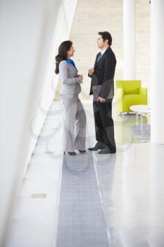 Businessman And Businesswomen Talking In Modern Office