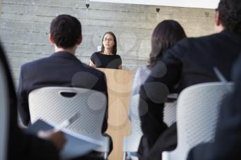 Businessman Delivering Presentation At Conference