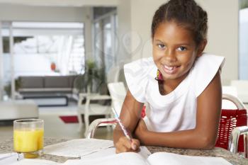 Girl Doing Homework In Kitchen