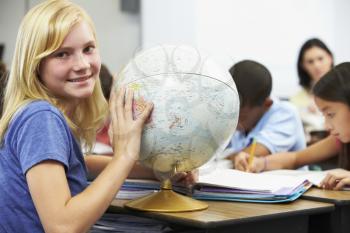 Pupils Studying Geography In Classroom