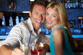 Couple Enjoying Cocktail In Bar