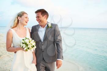 Bride And Groom Getting Married In Beach Ceremony