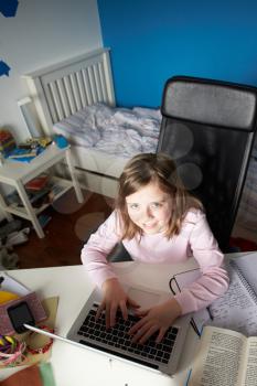 Girl Studying In Bedroom Using Laptop