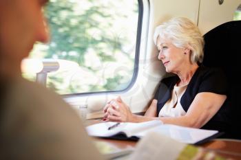 Businesswoman Relaxing On Train Journey