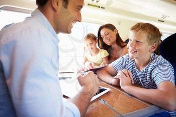 Family Relaxing On Train Journey