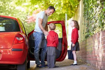 Father Driving To School With Children