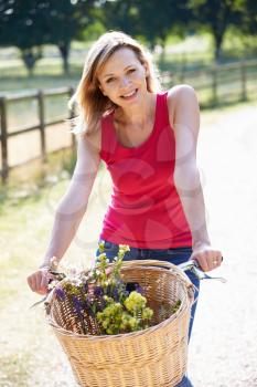 Attractive Woman Riding Bike Along Country Lane