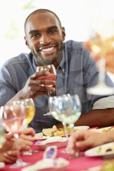 Young Man Relaxing At Dinner Party