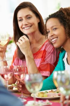 Two Women Relaxing At Dinner Party