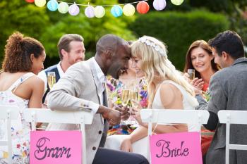 Bride And Groom Enjoying Meal At Wedding Reception