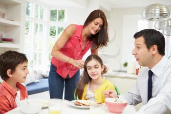 Family Having Breakfast Before Husband Goes To Work