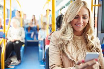 Woman Reading Text Message On Bus