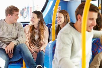 Group Of Young People On Bus Journey Together