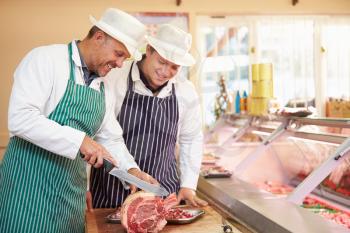 Butcher Teaching Apprentice How To Prepare Meat