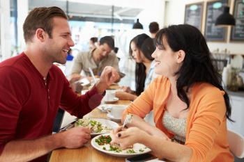 Couple Meeting For Lunch In Busy Caf
