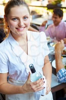 Waitress Serving Tables At Outdoor Restaurant