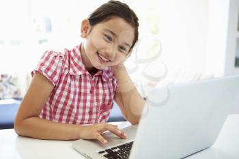 Asian Child Using Laptop At Home