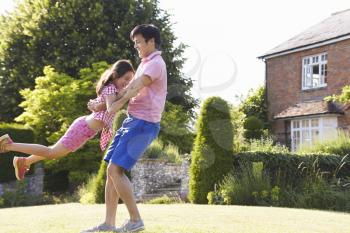 Asian Father And Daughter Playing In Summer Garden Together