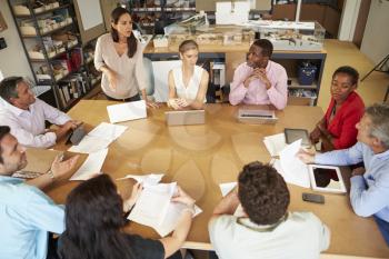 Architects Sitting At Table Meeting With Laptops And Tablets