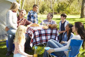 Two Families Enjoying Camping Holiday In Countryside