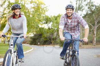 Couple On Cycle Ride In Countryside