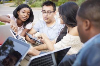 Group Of University Students Working On Project Outdoors