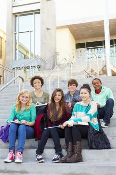 Portrait Of High School Students Sitting Outside Building