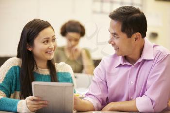 High School Student And Teacher Using Digital Tablet