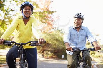 Senior Couple On Cycle Ride In Countryside