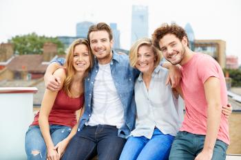 Group Of Friends Relaxing Together On Rooftop Terrace