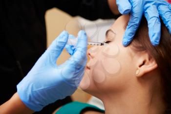 Woman Having Botox Treatment At Beauty Clinic