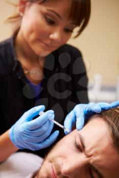 Man Having Botox Treatment At Beauty Clinic