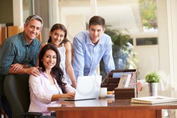 Portrait Of Family Using Laptop Together