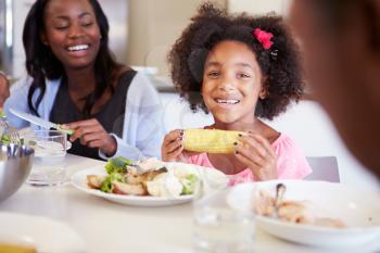 Mother And Daughter Having Family Meal At Table