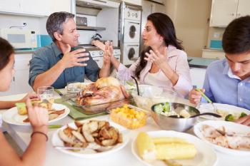 Family Having Argument Sitting Around Table Eating Meal