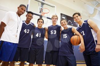 Members Of Male High School Basketball Team With Coach