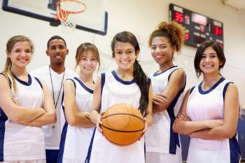 Members Of Female High School Basketball Team With Coach