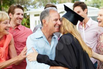 Female Student And Family Celebrating Graduation