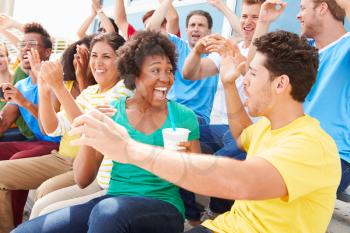 Spectators In Team Colors Watching Sports Event