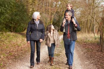 Grandparents With Grandchildren On Walk In Countryside